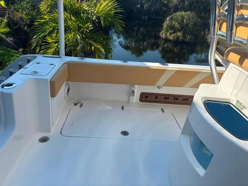 Slide: The Image of 2023 Prowler 25 boat deck with seating, rod holders, and scenic water view. - 33