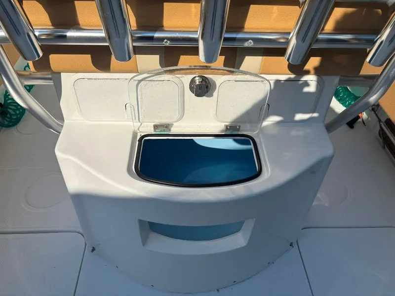 Slide: The Image of 2023 Prowler 25 boat interior with storage compartment and rod holders. - 34