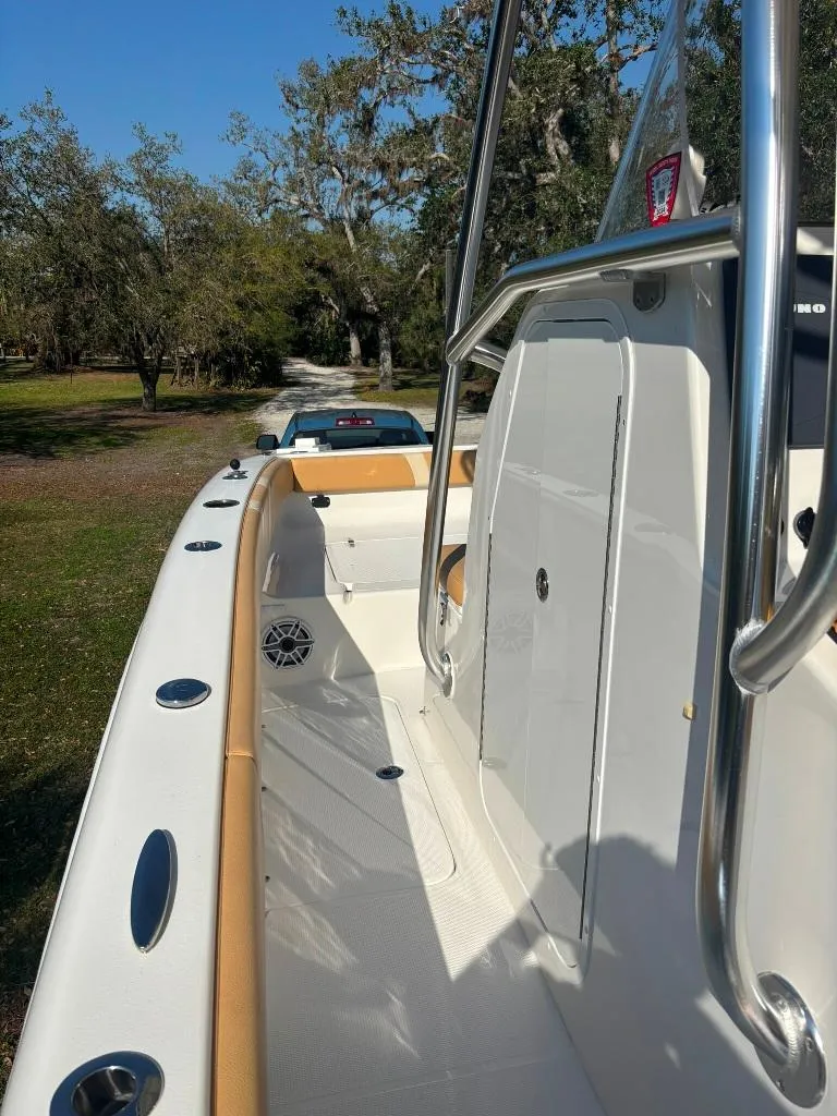 Slide: The Image of 2023 Prowler 25 boat, sleek design, stainless steel railings, spacious deck, outdoor setting. - 39