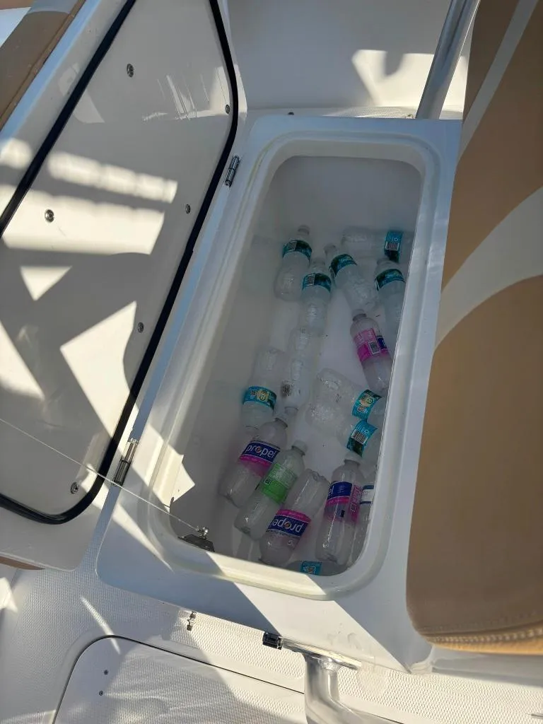 Slide: The Image of Cooler on 2023 Prowler 25 boat filled with water bottles. - 46