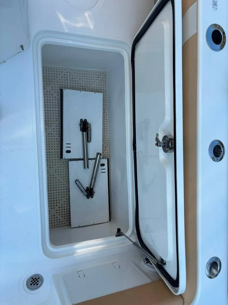 Slide: The Image of Open storage compartment on a 2023 Prowler 25 boat, showing interior details. - 49