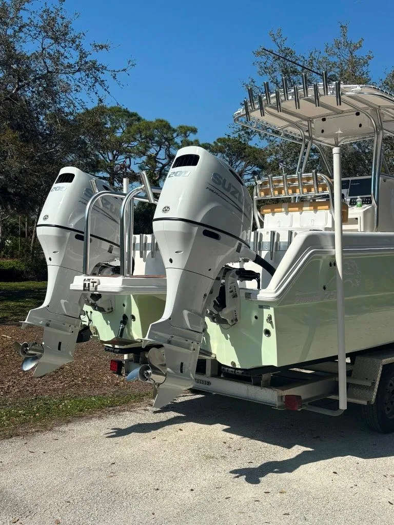Slide: The Image of 2023 Prowler 25 boat with dual Suzuki outboard motors on a trailer. - 7