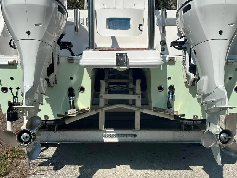 Slide: The Image of 2023 Prowler 25 boat with dual outboard motors, rear view. - 8