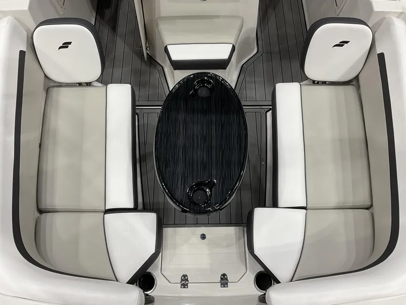 Slide: The Image of 2025 Starcraft SVX 211 OB CC boat interior with sleek seating and oval table. - 20