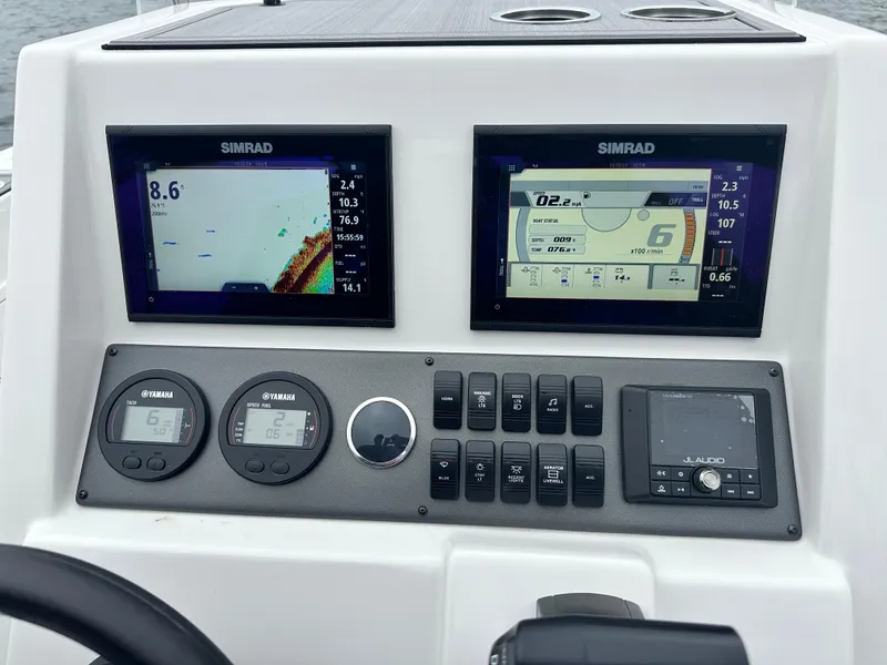 Slide: The Image of Control panel of 2025 Starcraft SVX 211 OB CC boat with Simrad displays. - 22