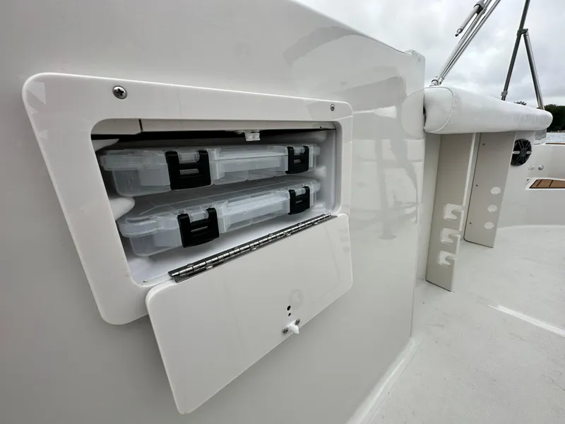 Slide: The Image of 2025 Starcraft SVX 211 OB CC boat storage compartment with tackle boxes. - 30