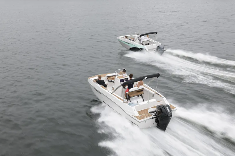 Slide: The Image of Two Starcraft SVX 211 OB CC boats cruising on open water, 2025 model. - 36