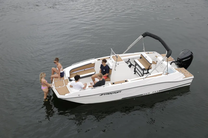 Slide: The Image of 2025 Starcraft SVX 211 OB CC boat with people enjoying water activities. - 39