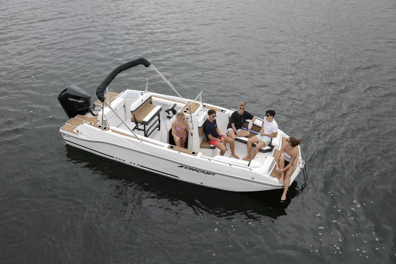 Slide: The Image of 2025 Starcraft SVX 211 OB CC boat with passengers on calm water. - 40