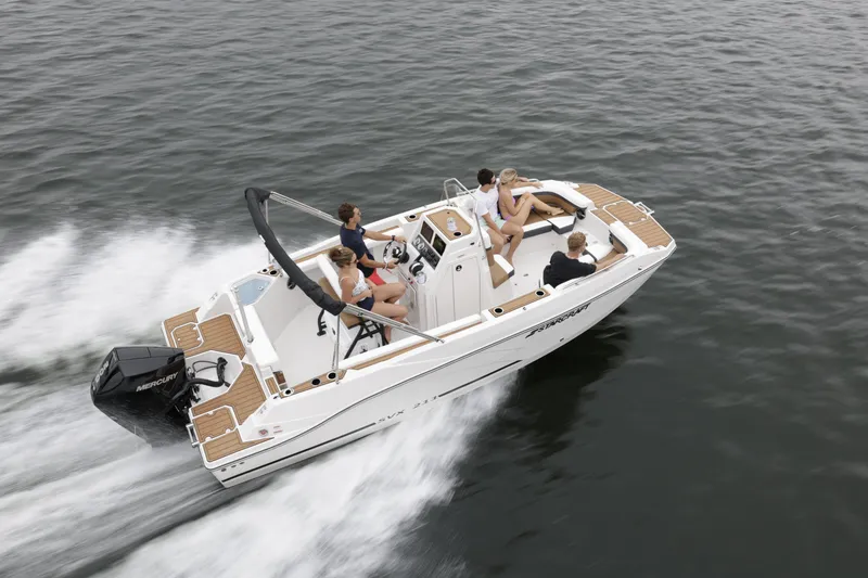 Slide: The Image of 2025 Starcraft SVX 211 OB CC boat cruising on open water with passengers. - 44