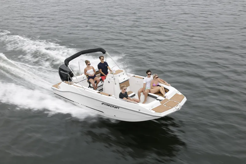 Slide: The Image of 2025 Starcraft SVX 211 OB CC boat cruising with passengers on open water. - 45
