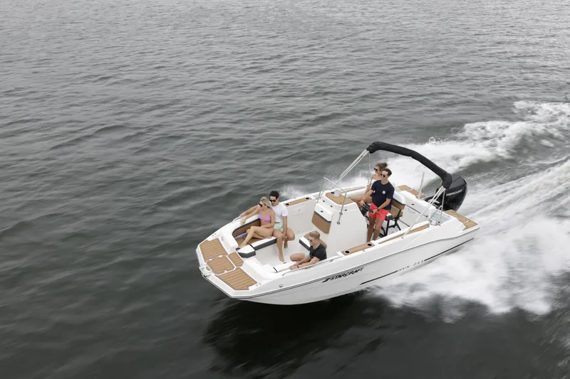 Slide: The Image of 2025 Starcraft SVX 211 OB CC boat cruising on open water with passengers. - 49