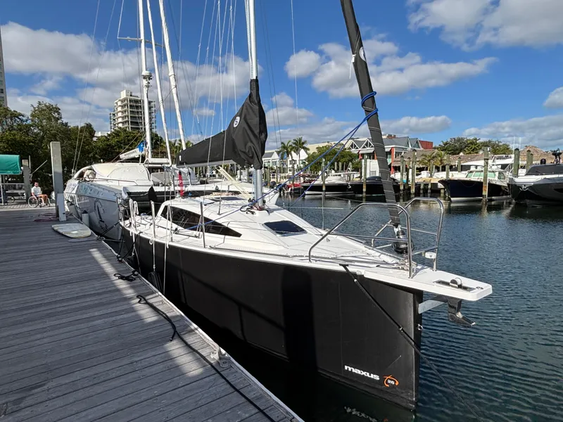 Slide: The Image of Sleek 2025 Maxus 26 yacht docked at marina under blue sky. - 1