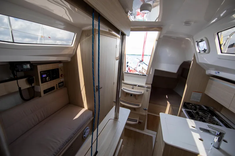 Slide: The Image of Interior of 2025 Maxus 26 sailboat, featuring modern kitchen and seating area. - 12