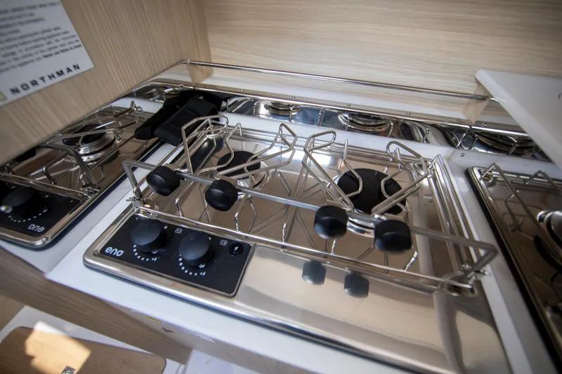 Slide: The Image of Modern kitchen stove in 2025 Maxus 26 yacht, featuring sleek stainless steel design. - 14