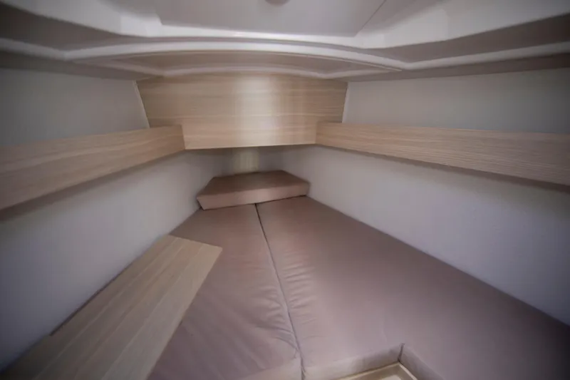 Slide: The Image of Interior cabin of 2025 Maxus 26 boat with cushioned seating and wooden accents. - 15