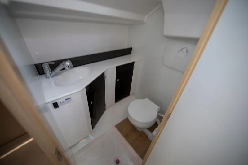 Slide: The Image of Compact bathroom in 2025 Maxus 26, featuring sink, toilet, and storage cabinets. - 16
