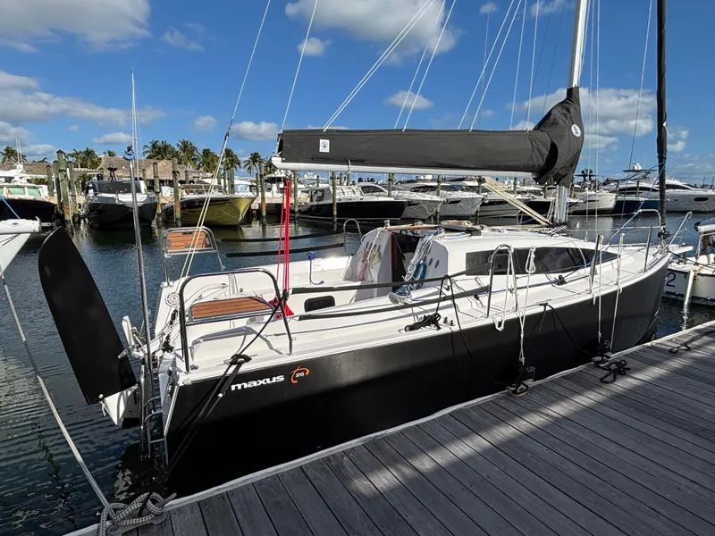 Slide: The Image of 2025 Maxus 26 sailboat docked at marina under blue sky. - 2