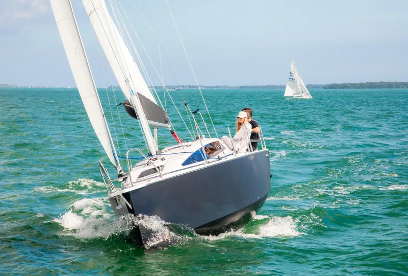 Slide: The Image of 2025 Maxus 26 sailboat navigating clear blue waters with sails unfurled. - 5