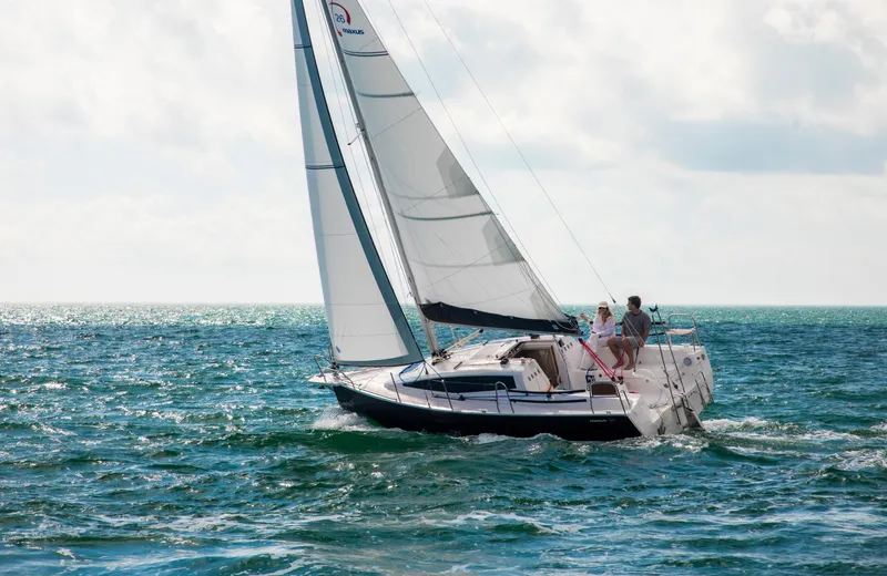 Slide: The Image of 2025 Maxus 26 sailboat navigating open sea under clear skies. - 6