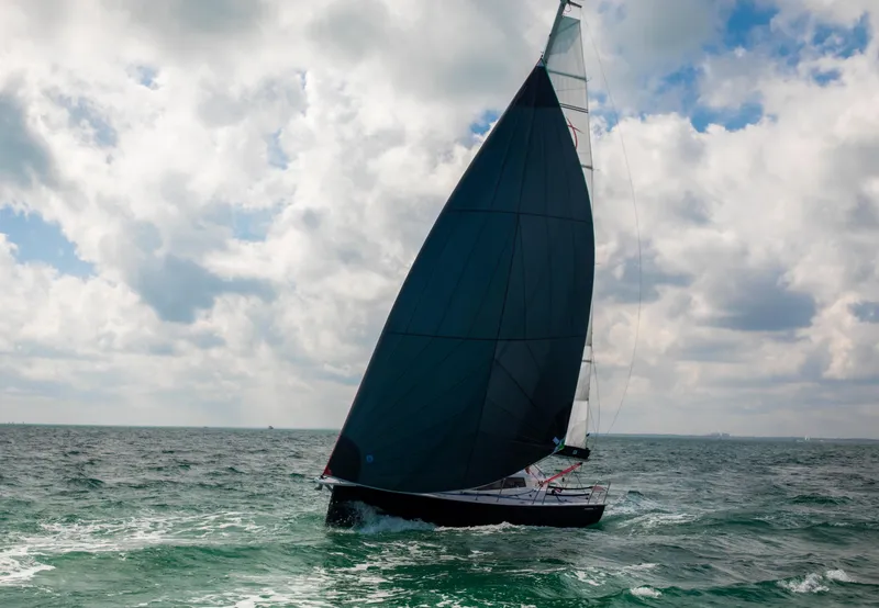 Slide: The Image of Sailing yacht Maxus 26, 2025 model, gliding on open sea under cloudy sky. - 9
