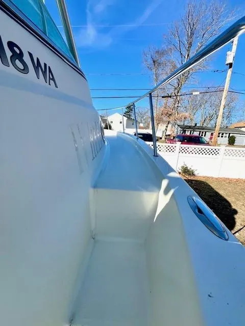 Slide: The Image of 2008 Sailfish 218 WAC boat side view, showcasing sleek design and railing. - 14