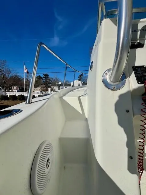 Slide: The Image of 2008 Sailfish 218 WAC boat deck with railing and speaker, under clear blue sky. - 15