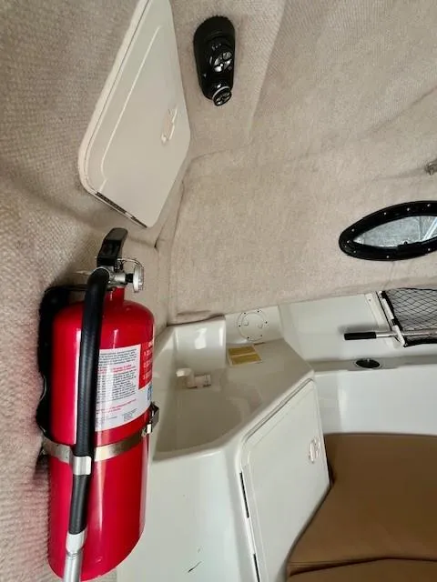 Slide: The Image of 2008 Sailfish 218 WAC interior with fire extinguisher and storage compartments. - 18