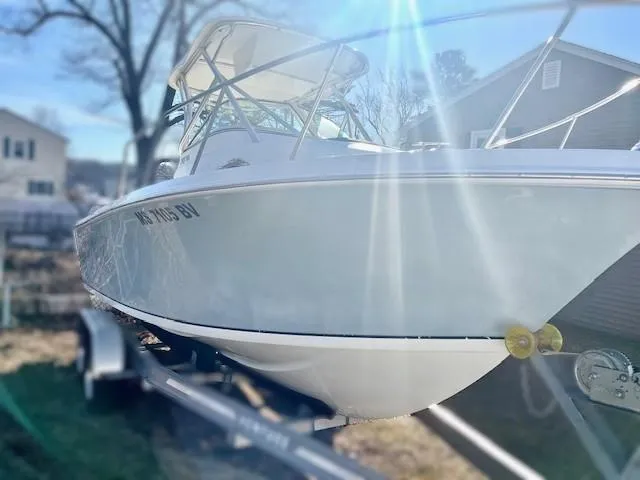 Slide: The Image of 2008 Sailfish 218 WAC boat on trailer, sunlit in residential area. - 5