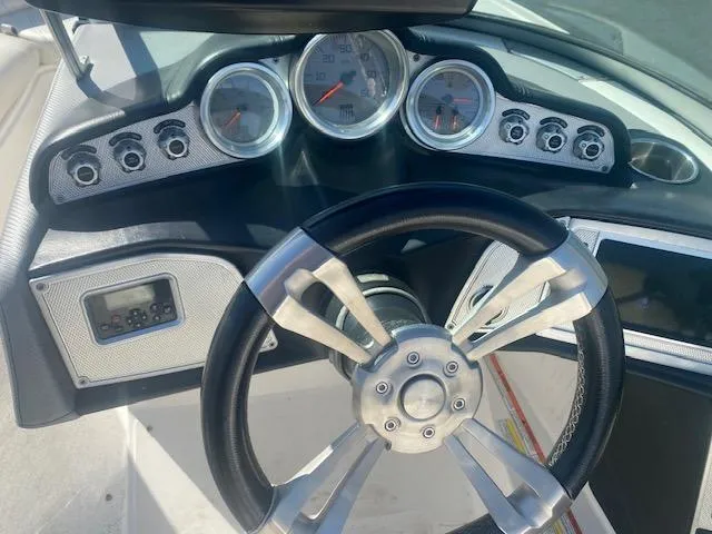 Slide: The Image of Steering wheel and dashboard of 2013 MasterCraft X-10 boat with gauges and controls. - 6