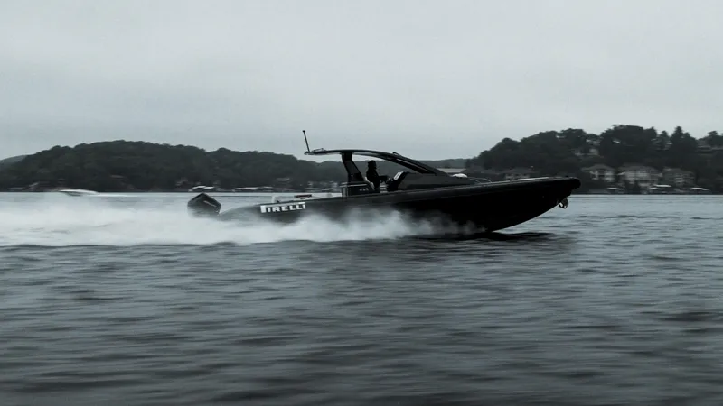 Slide: The Image of 2024 Pirelli 42 OB speedboat cruising on a lake with a scenic backdrop. - 5