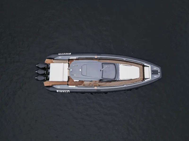 Slide: The Image of 2024 Pirelli 42 OB boat, aerial view, sleek design, on calm water. - 6
