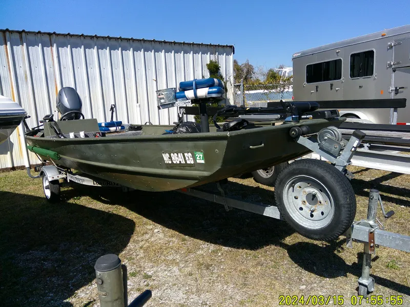 Slide: The Image of 2018 Alumacraft 1648 Jon boat on trailer, parked outdoors. - 3