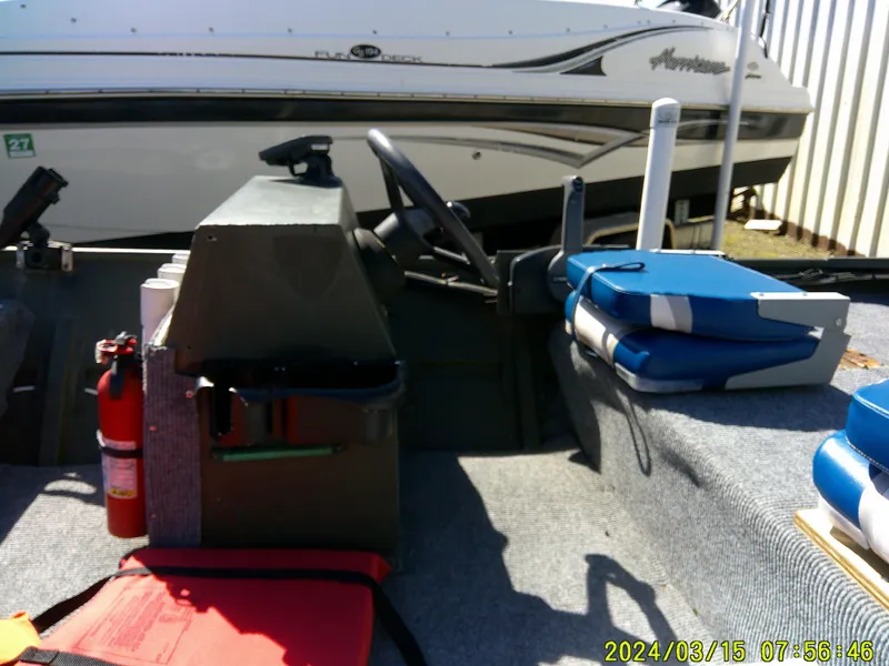 Slide: The Image of 2018 Alumacraft 1648 Jon boat interior with safety equipment and seating. - 9