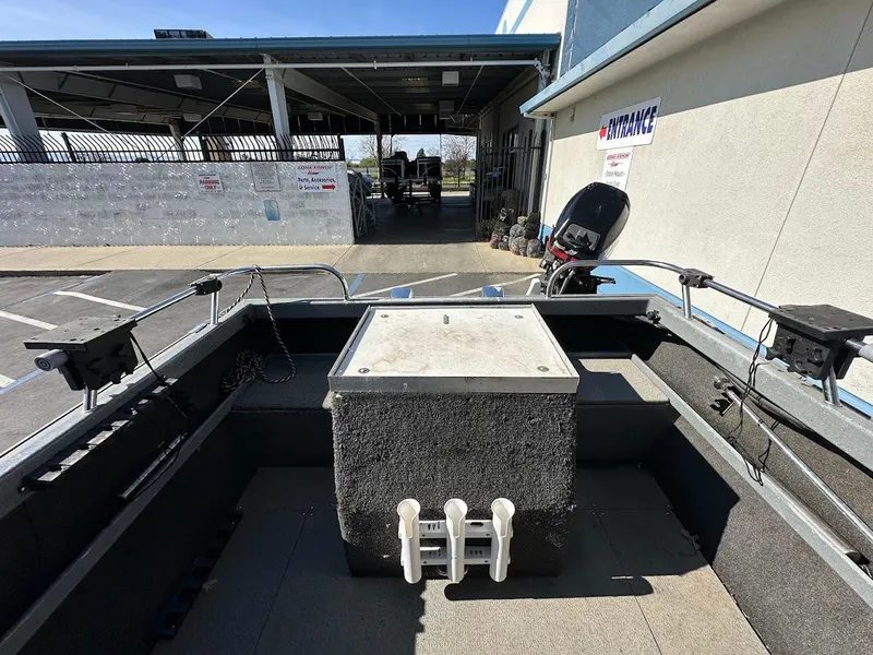 Slide: The Image of 2000 North River 19 Sportster boat interior with motor and storage compartment. - 14