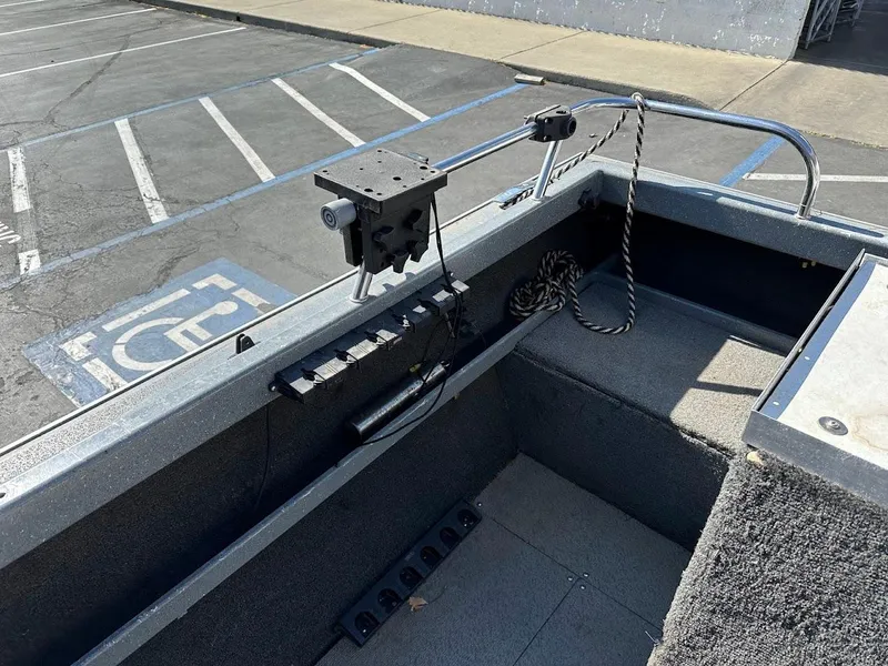 Slide: The Image of 2000 North River 19 Sportster boat interior with mounted equipment in a parking lot. - 15