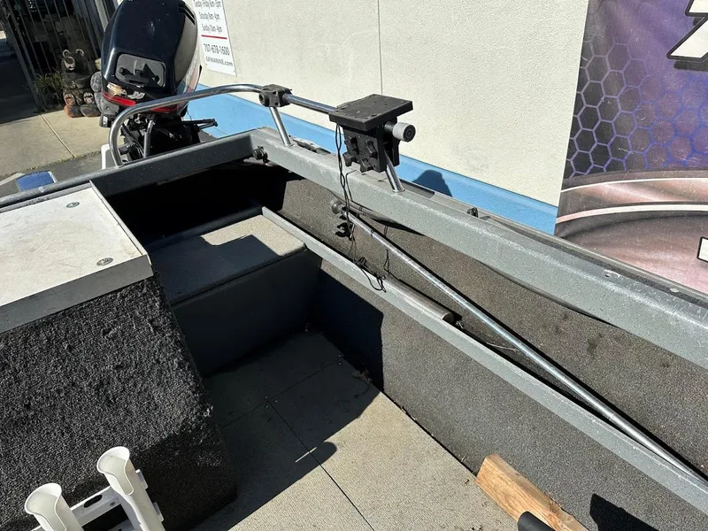 Slide: The Image of 2000 North River 19 Sportster boat interior with motor and seating area. - 17