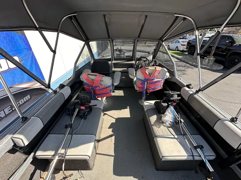 Slide: The Image of Interior of a 2000 North River 19 Sportster boat with seating and fishing gear. - 18