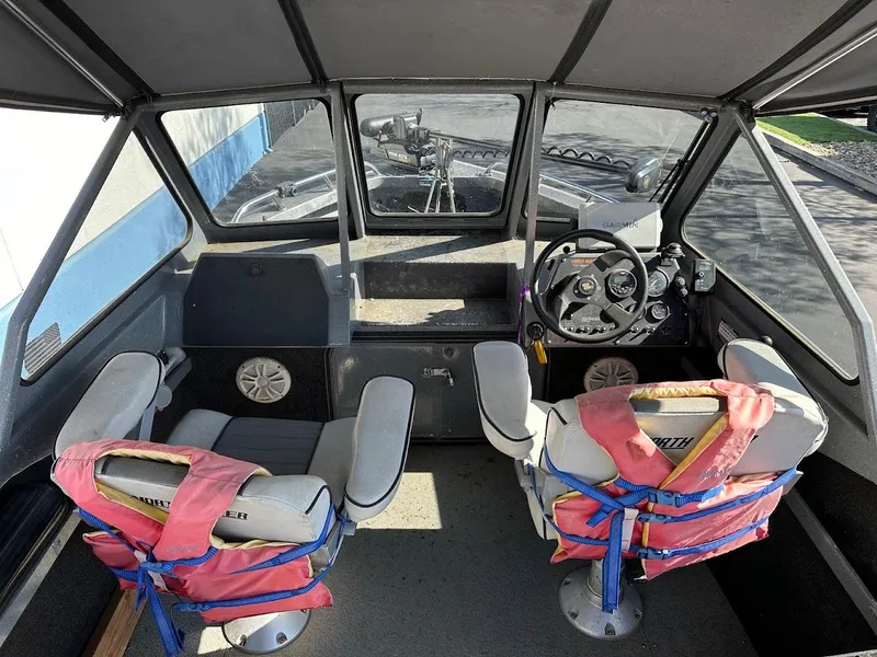 Slide: The Image of Interior of a 2000 North River 19 Sportster boat with two seats and life jackets. - 21