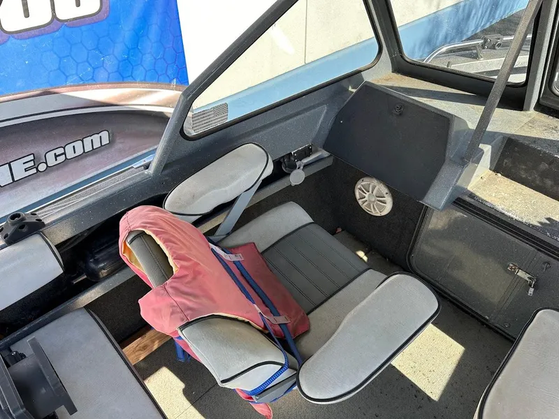 Slide: The Image of Interior of a 2000 North River 19 Sportster boat with seating and life jacket. - 22