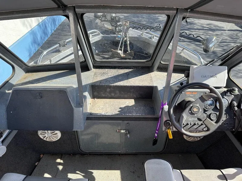 Slide: The Image of Interior of a 2000 North River 19 Sportster boat showing steering wheel and dashboard. - 23