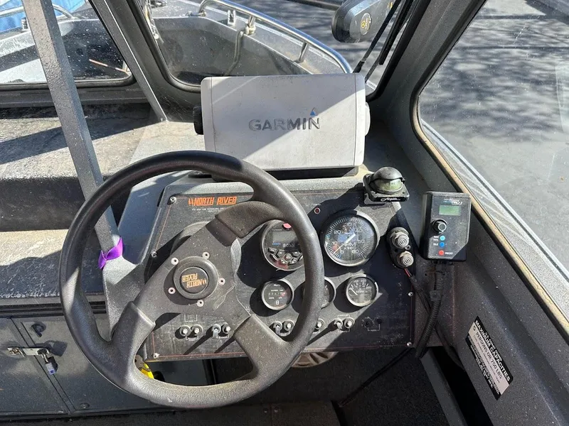 Slide: The Image of Dashboard of a 2000 North River 19 Sportster boat with Garmin navigation system. - 25
