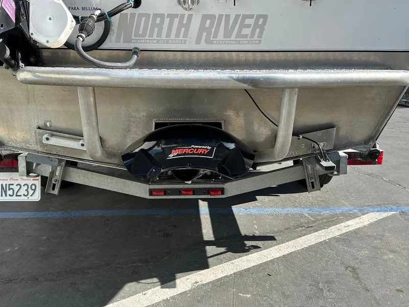Slide: The Image of Rear view of a 2000 North River 19 Sportster boat with Mercury engine. - 28