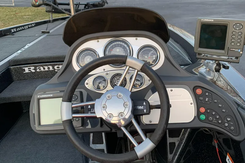 Slide: The Image of 2006 Ranger Z20 Comanche boat dashboard with steering wheel and navigation instruments. - 5
