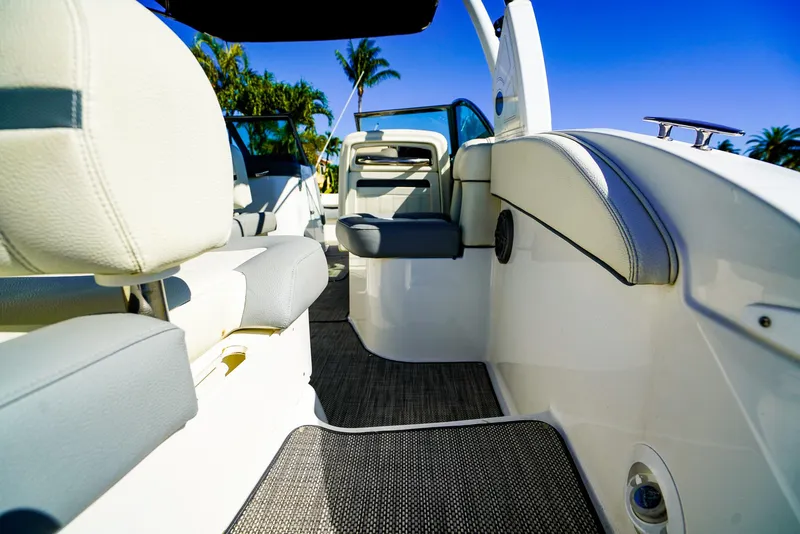 Slide: The Image of 2019 Cobalt 23SC boat interior with white seating and blue sky background. - 8