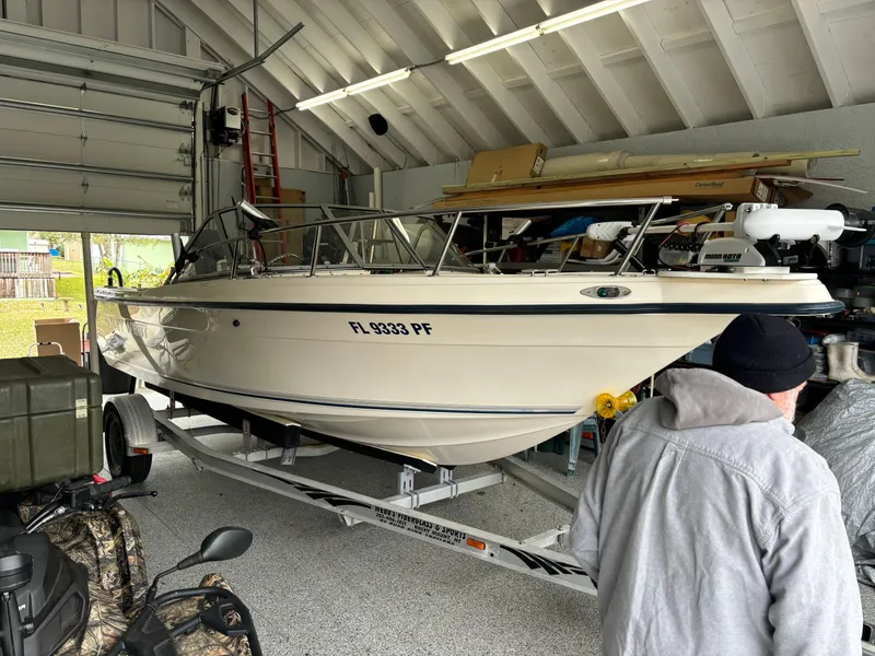 Slide: The Image of Key West 2020 Dual Console boat, 2004 model, stored in a garage on a trailer. - 1
