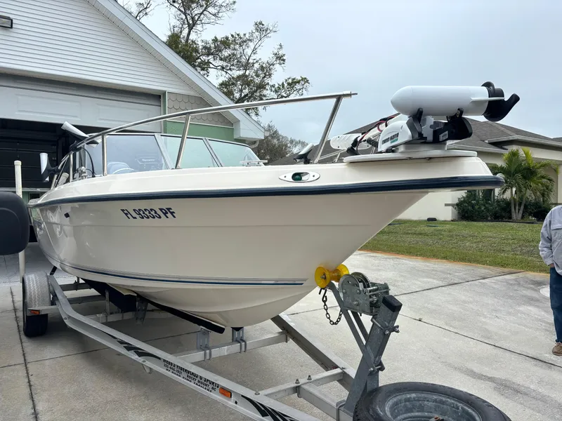 Slide: The Image of Key West 2020 Dual Console boat on trailer, parked in driveway, overcast day. - 5
