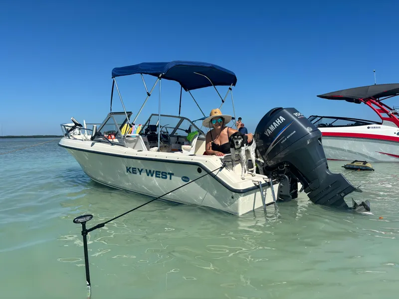 Slide: The Image of Key West 2020 Dual Console boat in shallow water, featuring Yamaha outboard motor. - 6