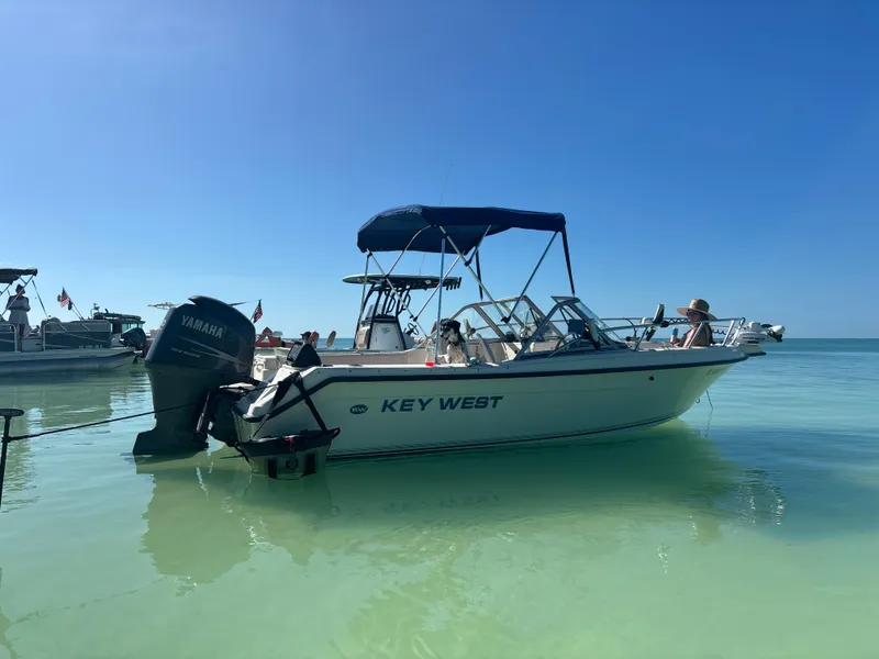 Slide: The Image of Key West 2020 Dual Console boat, 2004 model, anchored in clear blue water. - 7