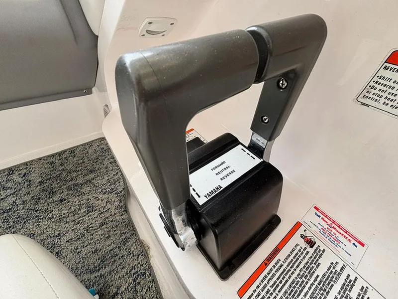 Slide: The Image of Throttle control lever on a 2004 Yamaha Boats 230 SX, featuring safety instructions. - 12